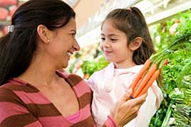 a mother and daughter shopping for carrots